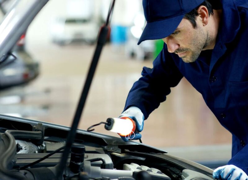 momak proverava sistem hlađenja na automobilu